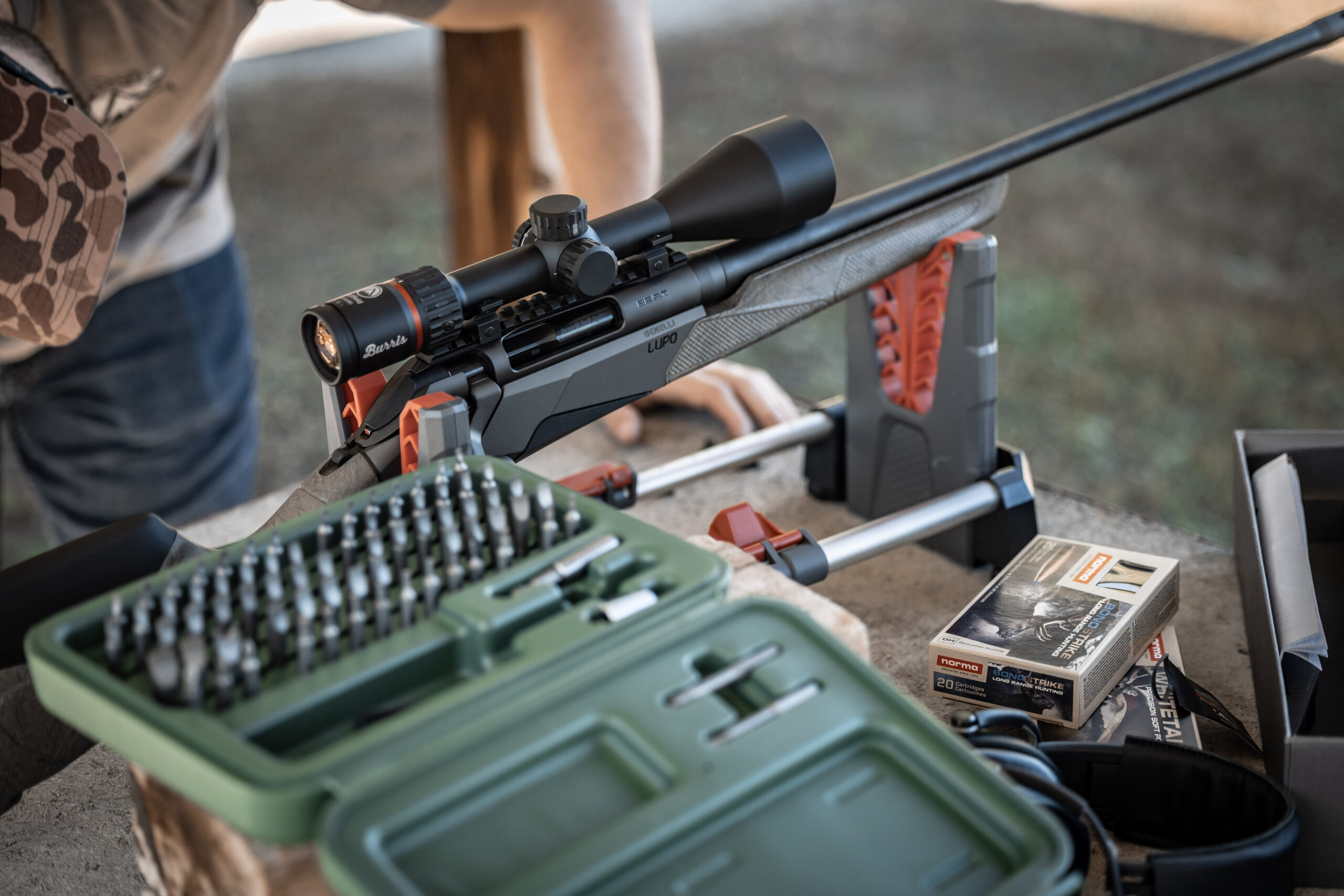 Shooter at range zeroing rifle